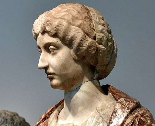 Roman Empress Faustina the Younger. This motherly portrayal with wavy hairstyle and the large bun was made in 161 CE on the occasion of the twin birth of boys. The grand bust made of alabaster dates from the early 18th century CE. Marble. Acquired in Paris, France, in 1742 CE. Altes Museum in Berlin.