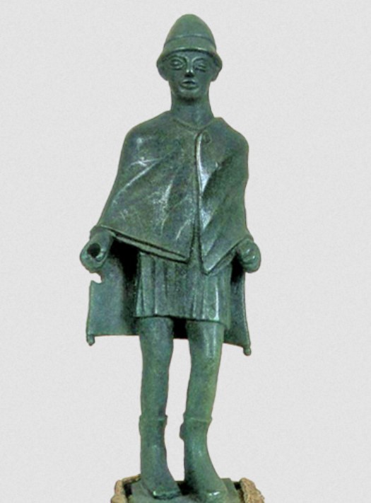 Hermes in travelling clothes: short chiton covered by the clamide and conical hat (pilos); bronze (5th century BC) - Athens, National Museum.