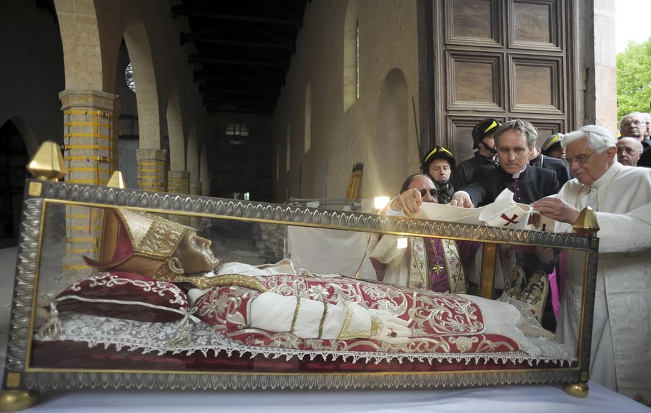 Pope Benedict XVI stands by the salvaged remains of Pope Celestine V, in the 13th-century Santa Maria di Collemaggio Basilica, in L'Aquila, Italy, in 2009.