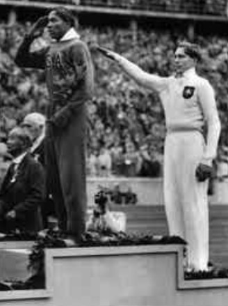 Berlin 1936 Olympic Games long jump award ceremony on August 4.  Gold Medalist Jesse Owens (USA), Silver Medalist Carl “Luz” Long (Germany), and Bronze Medalist Naoto Tajima (Japan)