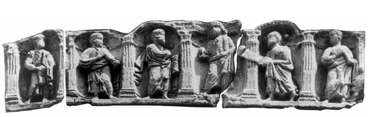 Farfa Abbey, Rieti, Italy. Reconstruction of the early Christian sarcophagus (4th century CE) with niches with Traditio Legis 'Delivery of the Law' by Christ to the apostle Peter, in the presence of Paul acclamating. Christ is in the center of the relief,  bearded and standing on the paradise mountain; while Paul is in the niche that follows his right, he is facing the Master who with his right hand (lost) makes the gesture of acclamatio while with his left holds a scroll.