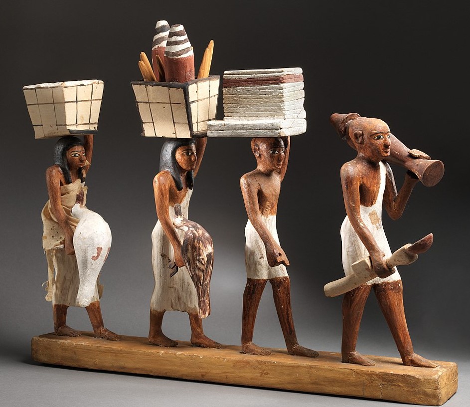 Model of a procession of offering bearers, reign of Amenemhat I, early. Plastered and painted wood, linen - Metropolitan Museum of Art, New York, USA