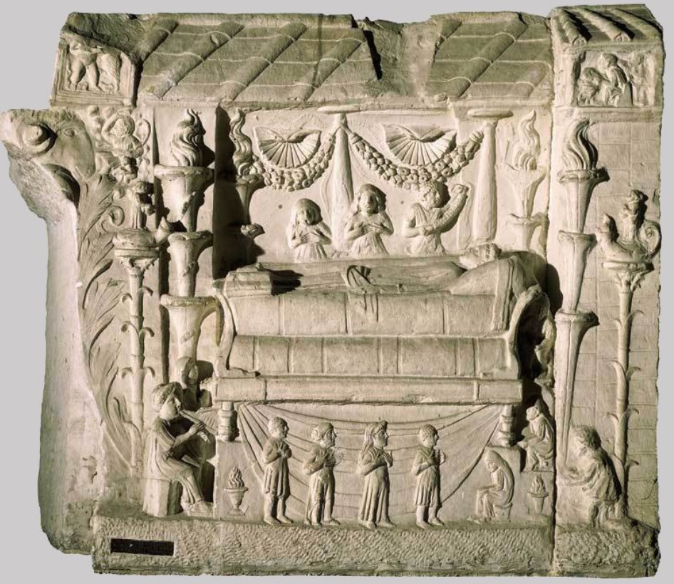 Collocatio relief from Tomb of the Haterii: a funerary scene with a deceased figure on a bed surrounded by lit candelabra, mourners, and servants - Vatican Museum, Rome.