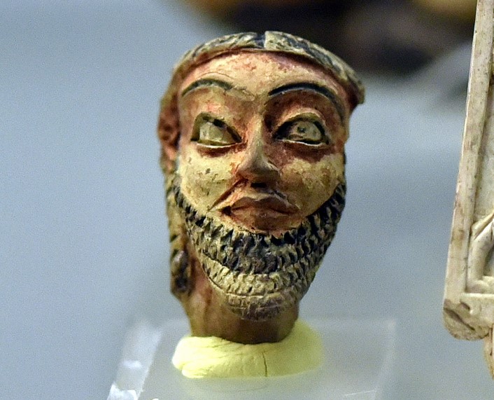 Terracotta head, painted red and black, from the Royal Palace at Dur-Kurigalzu (Aqar Quf), Iraq. Probably representing a court dignitary. The overall depiction dates this head to the reign of Marduk-apla-iddina I, 1171-1159 BCE. On display at the Iraq Museum in Baghdad.